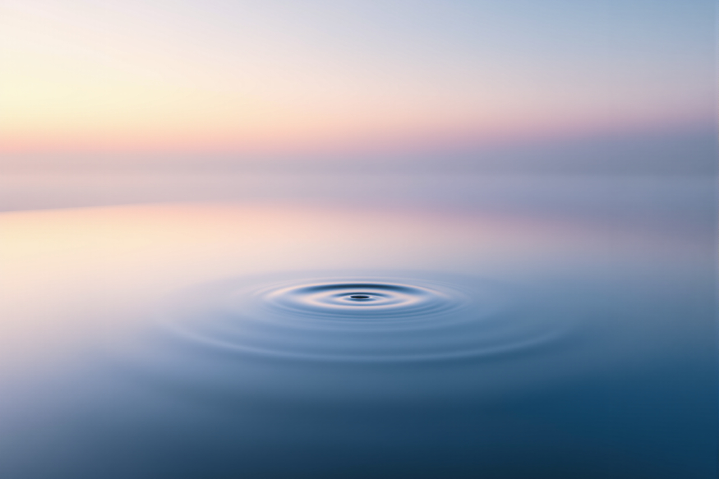 Still water at dawn with faint mist, calm and meditative